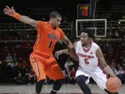 Stanford guard Chasson Randle, right, dribbles around Oregon State guard Gary Payton II during the second half Thursday, Feb. 26, 2015, in Stanford, Calif. Stanford won 75-48.