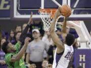 Washington's Shawn Kemp Jr. shoots with Oregon's Jordan Bell defending in the first half Sunday, Jan. 18, 2015, in Seattle.