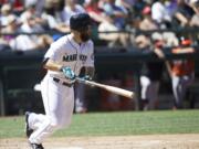 Seattle Mariners' Dustin Ackley runs to first as he hits a double in the fifth inning Saturday against the Baltimore Orioles.