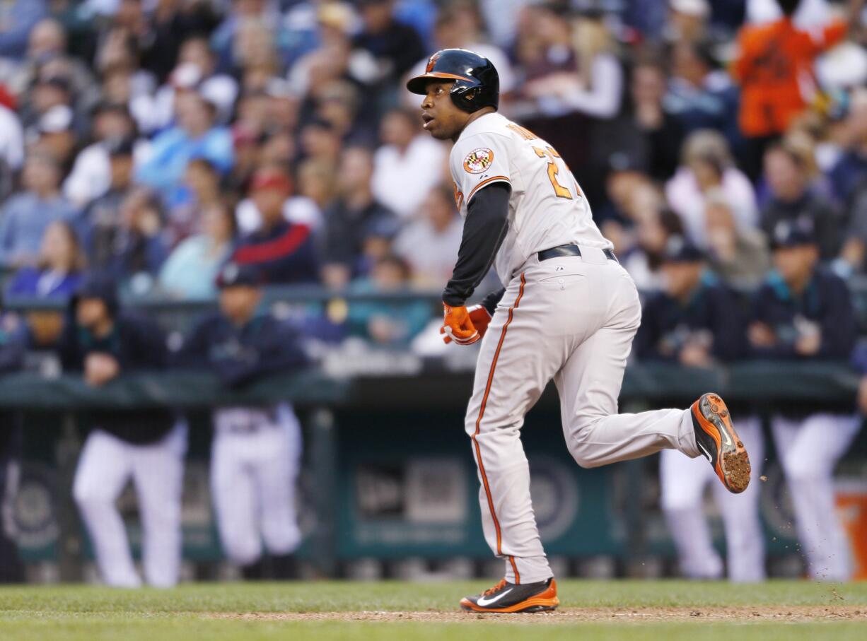 Baltimore Orioles' Delmon Young runs to first watching the flight of his three-run home run ball he hit on a pitch from Seattle Mariners' Hisashi Iwakuma during the third inning of a baseball game on Thursday, July 24, 2014 in Seattle.