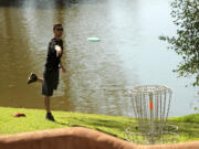 Disc golfer Cameron Lincoln lines up a putt in February during the final round of the 2015 Memorial tournament at Fiesta Lakes disc-golf course in Fountain Hills, Ariz.