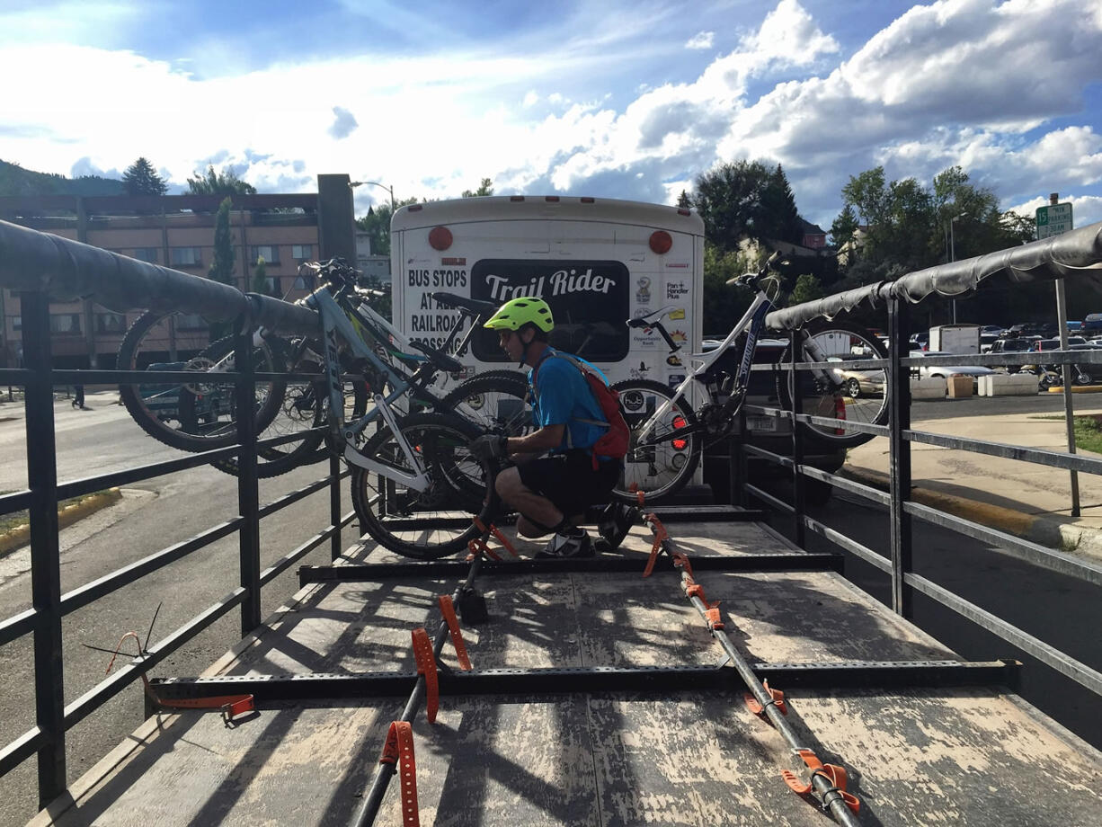 Emmett Purcell loads a mountain bike on the Helena, Mont., Trail Rider Shuttle.