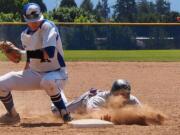 Clackamas base runner Shane Suyama dives back to first base as Clark College's Boyd Lainhart turns to make a tag during the first game of a doubleheader on Saturday, May 9, 2015, at Kindsfather Field.