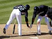 Seattle Mariners' Nelson Cruz , right, celebrates with Robinson Cano (22) after hitting a two-run home run during the third inning against the San Diego Padres on Thursday, March 5, 2015, in Peoria, Ariz.