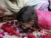 A Pakistani Christian girl mourns the death of a family member in Lahore, Pakistan, on Monday.