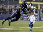 Seattle's Kam Chancellor (31) dives to take down Carolina's DeAngelo Williams during the NFL divisional playoff game.