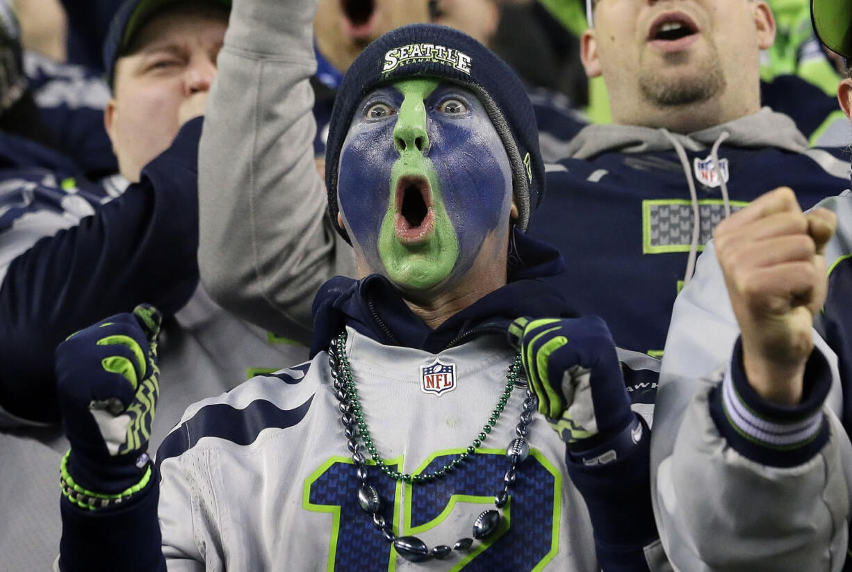 A Seattle Seahawks fan cheers during the second half of an NFL divisional playoff football game between the Seahawks and the Carolina Panthers in Seattle on Saturday.