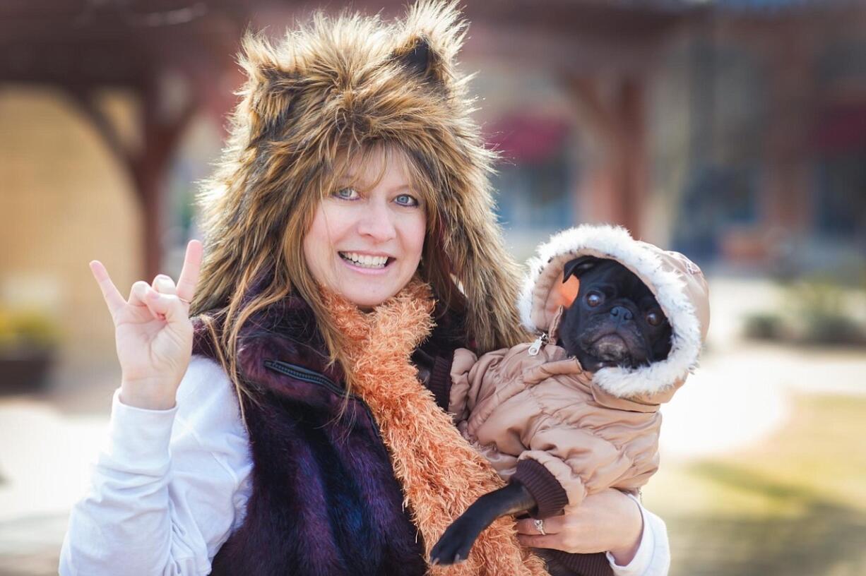 Robin Young, holds Faith the Pug, a foster dog, at The Promenade in Charlotte, N.C.