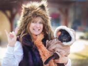 Robin Young, holds Faith the Pug, a foster dog, at The Promenade in Charlotte, N.C.