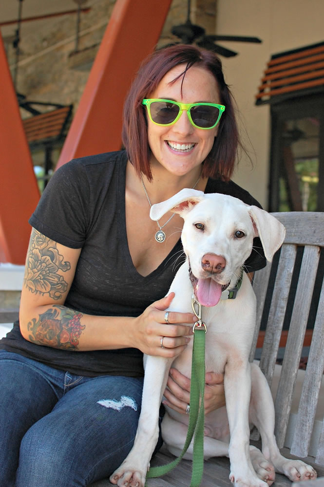 Carrie Santiago, and her foster dog, Basil, visit Grand Boulevard Town Center in Miramar Beach, Fla., in 2014.