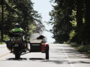 Gary McLuen, with his dog Jake the Wonderdog, ride in a 2008 BMW GS/A motorcycle in Port Townsend. These dogs are set apart by speed instead of breed and like to fly like the wind in a blimp-shaped bucket attached to the side of a motorcycle.