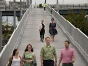 Pedestrians walk down a ramp from the South Street Bridge to the Schuylkill Banks Boardwalk on Oct. 2 in Philadelphia.