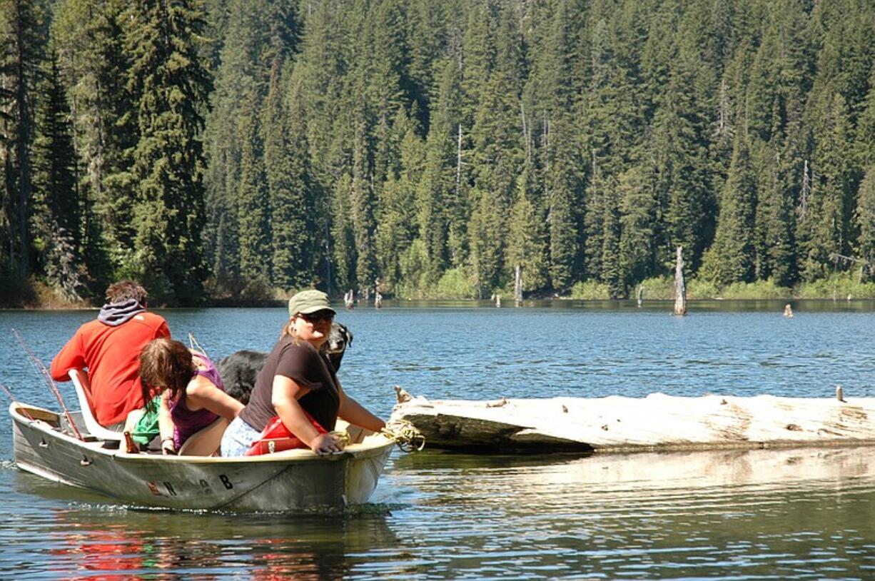 A trio of anglers return to the shoreline of Goose Lake in the Gifford Pinchot National Forest.