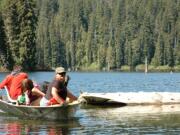 A trio of anglers return to the shoreline of Goose Lake in the Gifford Pinchot National Forest.