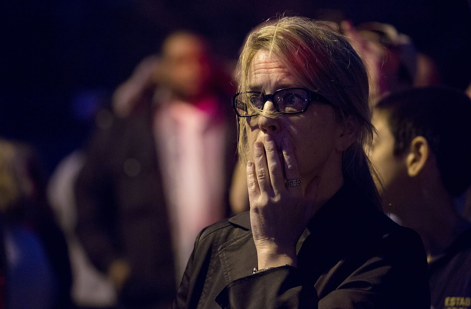 Mimi de Quesada, of Watertown, Mass., reacts while standing by her home in the wake of the sound of shots fired in Watertown, Mass., on Friday as a massive search continued for one of two suspects in the Boston Marathon bombings. De Quesada said she had just come out to enjoy the day when the shots rang out about two blocks form her home.