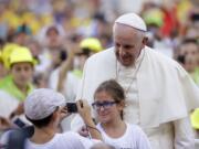 Associated Press files
Pope Francis poses for a photo this month as he arrives in St. Peter's Square at the Vatican for an audience with altar boys and girls. Democrats and Republicans are looking forward to Francis' remarks to Congress next month.