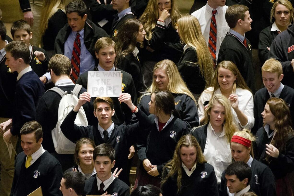 A Catholic school student holds up a sign ahead of a news conference Monday at the Philadelphia Museum of Art in Philadelphia.