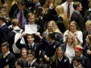 A Catholic school student holds up a sign ahead of a news conference Monday at the Philadelphia Museum of Art in Philadelphia.