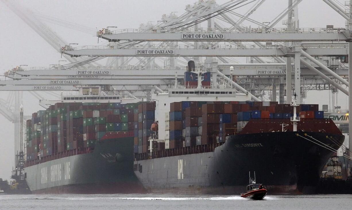 Container ships wait to be off-loaded at the Port of Oakland in Oakland, Calif., in October.