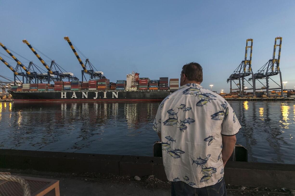 A Longshoreman with the union's Local 13 looks out Jan. 14 at the unusually quiet dock at the Port of Los Angeles. Contract talks art expected to resume Friday after the parties took Thursday off. Longshoremen dispute employer statistics that indicate their productivity has dropped and say employers are cutting back jobs to hurt workers and pressure negotiators for their union into a bad deal.