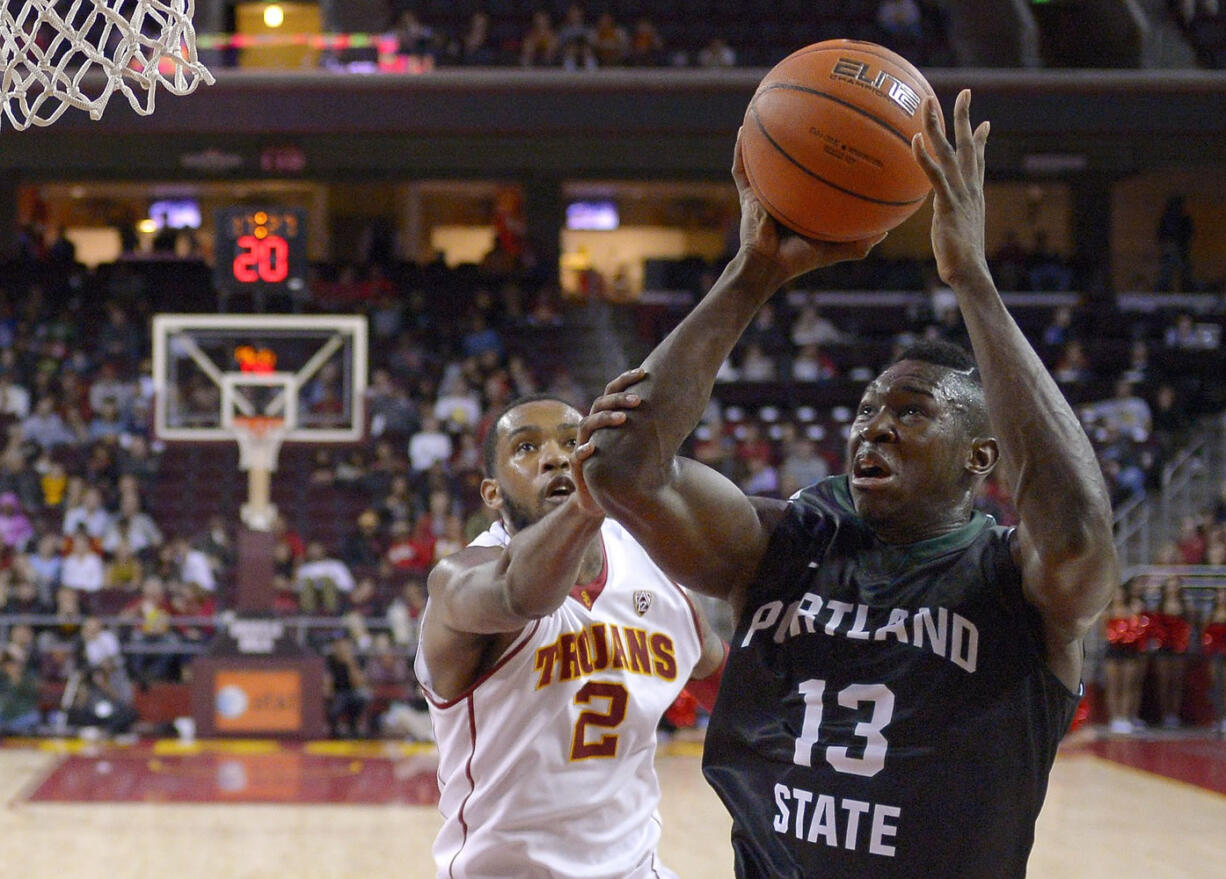 Portland State forward Tiegbe Bamba shoots as Southern California forward Malik Martin defends during the second half Saturday, Nov. 15, 2014, in Los Angeles. Portland State won 76-68. (AP Photo/Mark J.