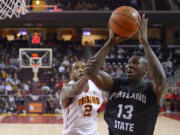 Portland State forward Tiegbe Bamba shoots as Southern California forward Malik Martin defends during the second half Saturday, Nov. 15, 2014, in Los Angeles. Portland State won 76-68. (AP Photo/Mark J.