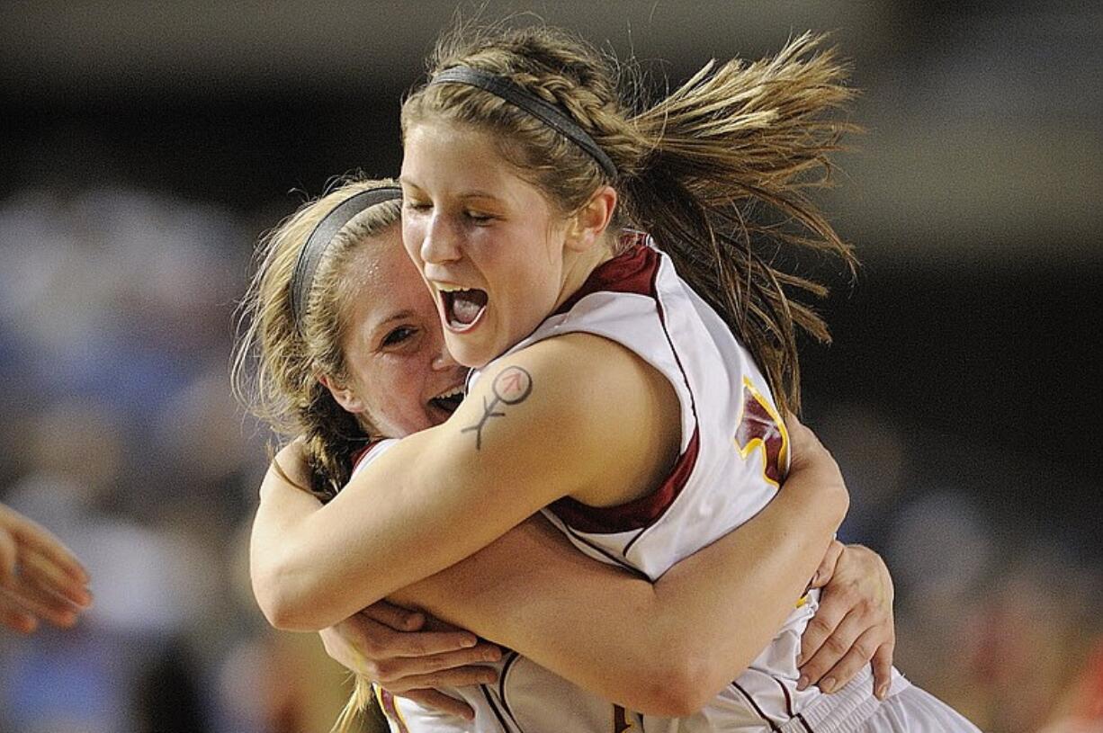 Prairie's Angela Gelhar, left, celebrates with teammate Cori Woodward after the Falcons beat Kamiakin High School in their Class 3A state semifinal game on Friday at the Tacoma Dome.