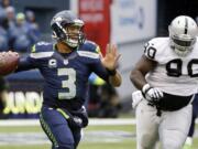 Seattle Seahawks quarterback Russell Wilson (3), is chased by Oakland Raiders' Pat Sims, acknowledged he did not play well at all in Sunday's game.