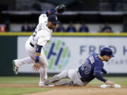 Seattle Mariners second baseman Robinson Cano, left, is tripped by the feet of Tampa Bay Rays' Steven Souza Jr.