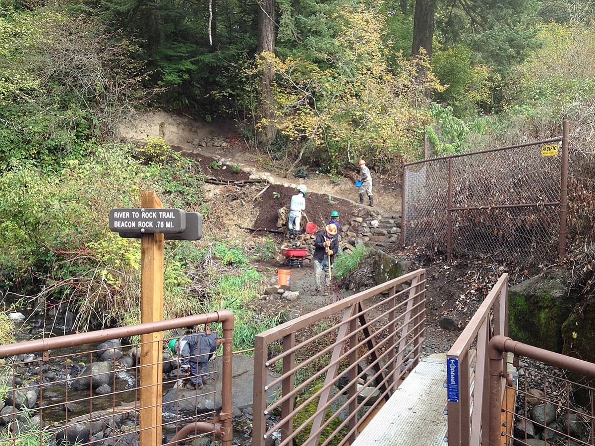 Ryan Ojerio/Washington Trails Association 
 Washington Trails Association volunteers finish the stone steps up the River to Rock Trail, a new connector path that links the day-use area to the trail to the top of Beacon Rock State Park.