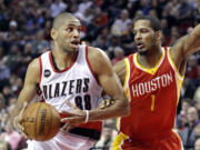 Portland Trail Blazers forward Nicolas Batum, left, drives on Houston Rockets forward Trevor Ariza during the second half of an NBA basketball game in Portland, Ore., Wednesday, March 11, 2015. Portland won 105-100.