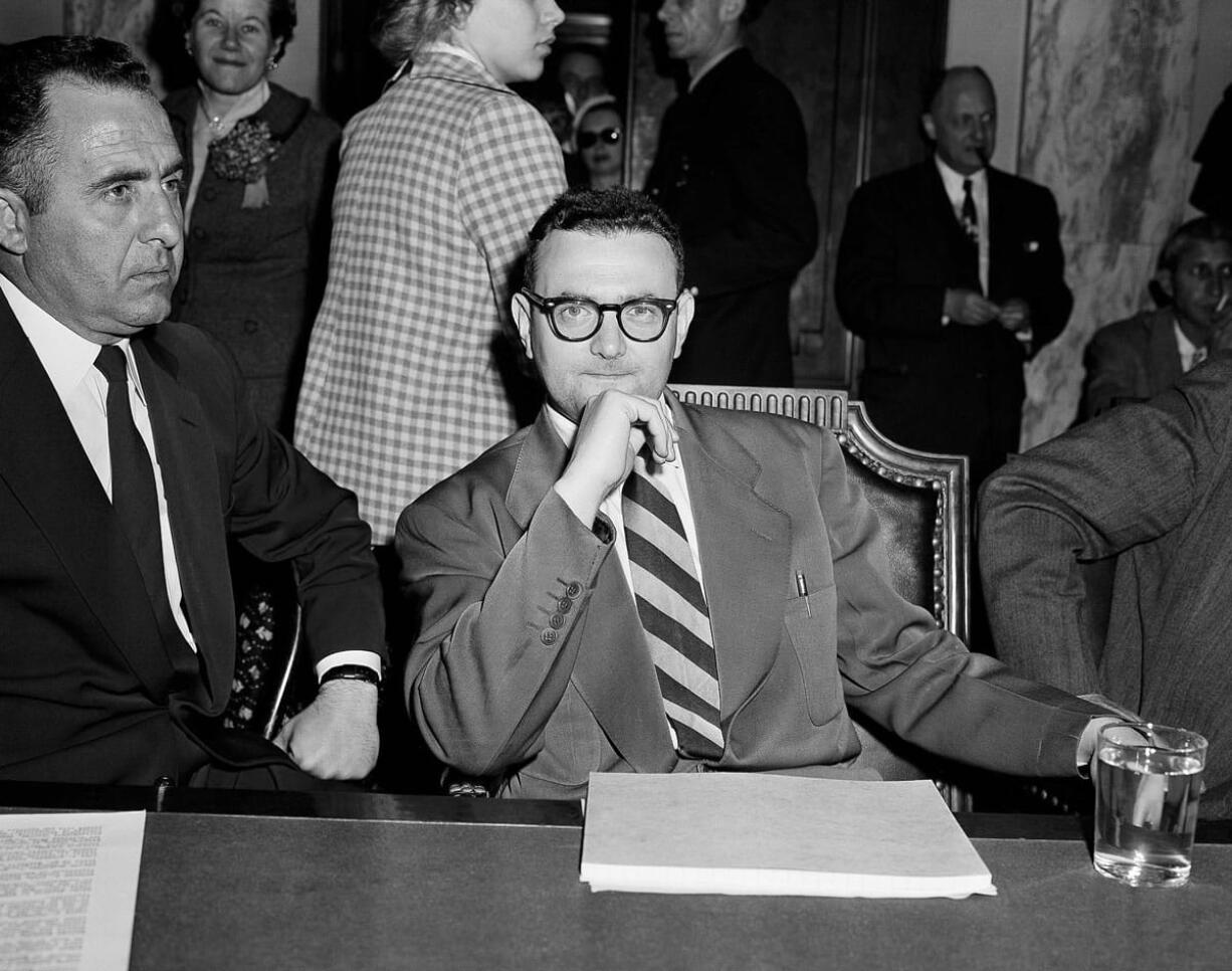 David Greenglass, convicted atomic spy, sits beside Deputy U.S.