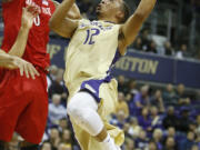 Washington guard Andrew Andrews (12) goes up for a basket against San Diego State forward Skylar Spencer (0) in the first half Sunday, Dec. 7, 2014, in Seattle.