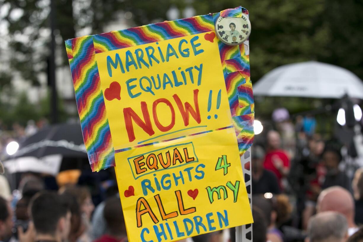 A woman carries a sign in favor of same sex marriage outside of the Supreme Court on June 26, in Washington after the court declared that same-sex couples have a right to marry anywhere in the U.S.