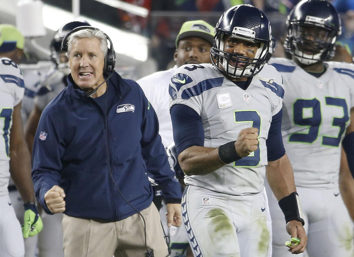 Seattle Seahawks head coach Pete Carroll, left, and quarterback Russell Wilson (3) celebrate during the fourth quarter against the San Francisco 49ers in Santa Clara, Calif., Thursday, Nov. 27, 2014.