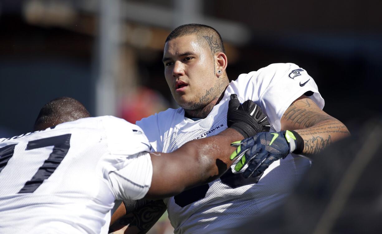 Seattle Seahawks' Jesse Williams, right, works through a drill during training camp on Thursday in Renton.