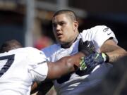 Seattle Seahawks' Jesse Williams, right, works through a drill during training camp on Thursday in Renton.