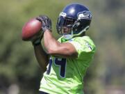 Seattle Seahawks linebacker Bobby Wagner catches a ball in drills during the first day of training camp on Friday, July 31, 2015, in Renton.