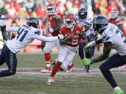 Kansas City Chiefs running back Jamaal Charles (25) carries the ball past Seattle Seahawks cornerback Byron Maxwell (41) in the second half Sunday, Nov. 16, 2014. Charles rushed for 159 yards and two touchdowns in the Chiefs' 24-20 win.