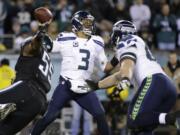 Seattle Seahawks' Russell Wilson passes during the second half against the Philadelphia Eagles, on Sunday, Dec. 7, 2014, in Philadelphia. Wilson had 263 passing yards and two TD passes in the 24-14 Seahawks' victory.