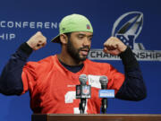 Seattle Seahawks quarterback Russell Wilson raises his arms and ends his remarks to reporters with his traditional &quot;Go Hawks!,&quot; Wednesday before practice in Renton. The Seahawks will face the Green Bay Packers, Sunday in the NFC Championship game. (AP Photo/Ted S.