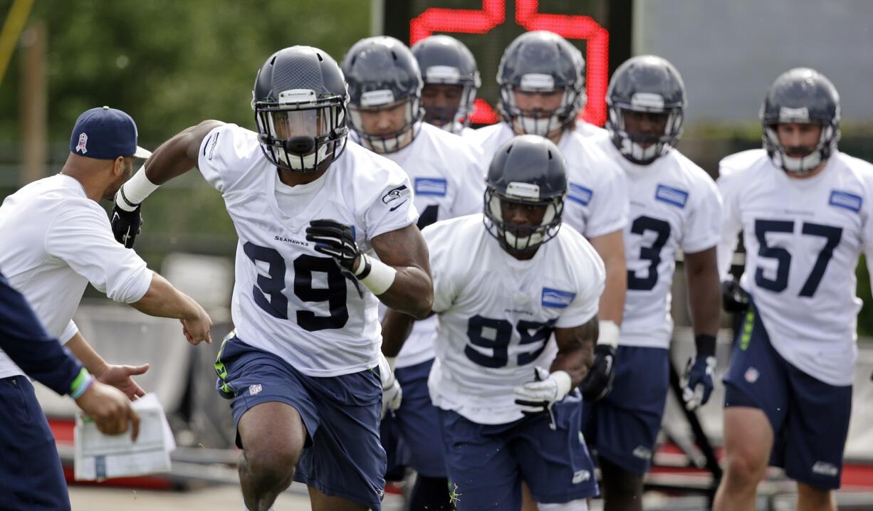 Eric Pinkins (39) leads others as they take part in drills at Seattle Seahawks rookie minicamp Sunday, May 10, 2015, in Renton.