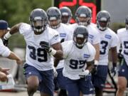 Eric Pinkins (39) leads others as they take part in drills at Seattle Seahawks rookie minicamp Sunday, May 10, 2015, in Renton.