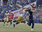 Seattle Seahawks' Jermaine Kearse, right, catches the game-winning touchdown pass during overtime of the NFC championship NFL football game against the Green Bay Packers in Seattle.