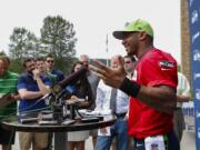 Seattle Seahawks quarterback Russell Wilson answers questions during a press conference following the conclusion of minicamp Thursday, June 18, 2015, in Renton.