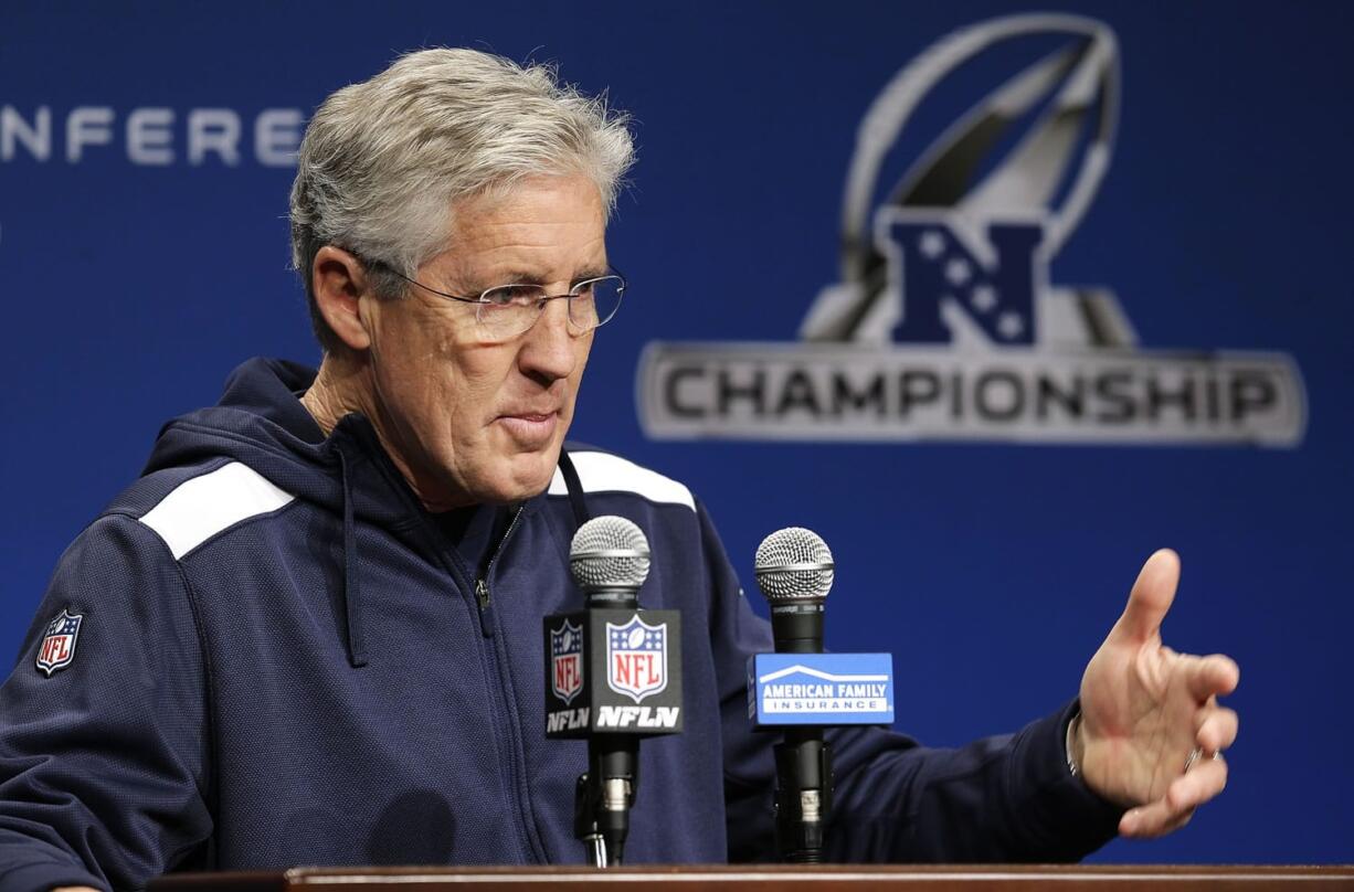 Seattle Seahawks head coach Pete Carroll talks to reporters Wednesday, Jan. 14, 2015 before NFL football practice in Renton. The Seahawks will face the Green Bay Packers Sunday in the NFC Championship game. (AP Photo/Ted S.