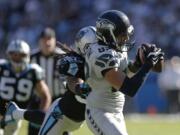 Carolina Panthers strong safety Tre Boston (33) tries to stop Seattle Seahawks tight end Luke Willson (82) as he makes the go-ahead touchdown catch in the fourth quarter Sunday, Oct.