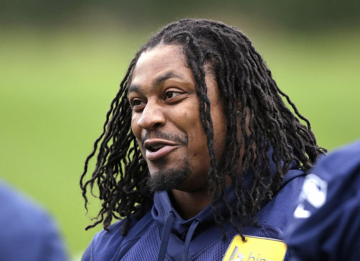 In this June 17 photo, Seattle Seahawks' Marshawn Lynch attends a football minicamp practice that he watched from the sidelines in Renton.