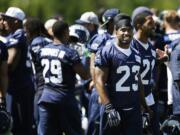 Seattle Seahawks strong safety Jeron Johnson (23) stands with teammates as the huddle breaks up following a session of NFL football training camp, Tuesday, Aug. 5, 2014, in Renton, Wash. (AP Photo/Ted S.