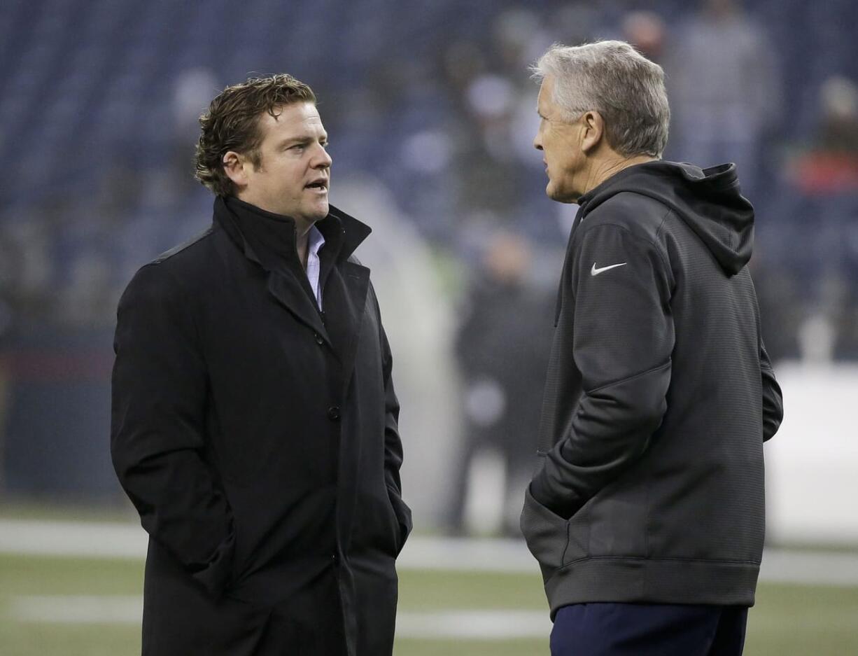 Seattle Seahawks general manager John Schneider, left, talking with head coach Pete Carroll.